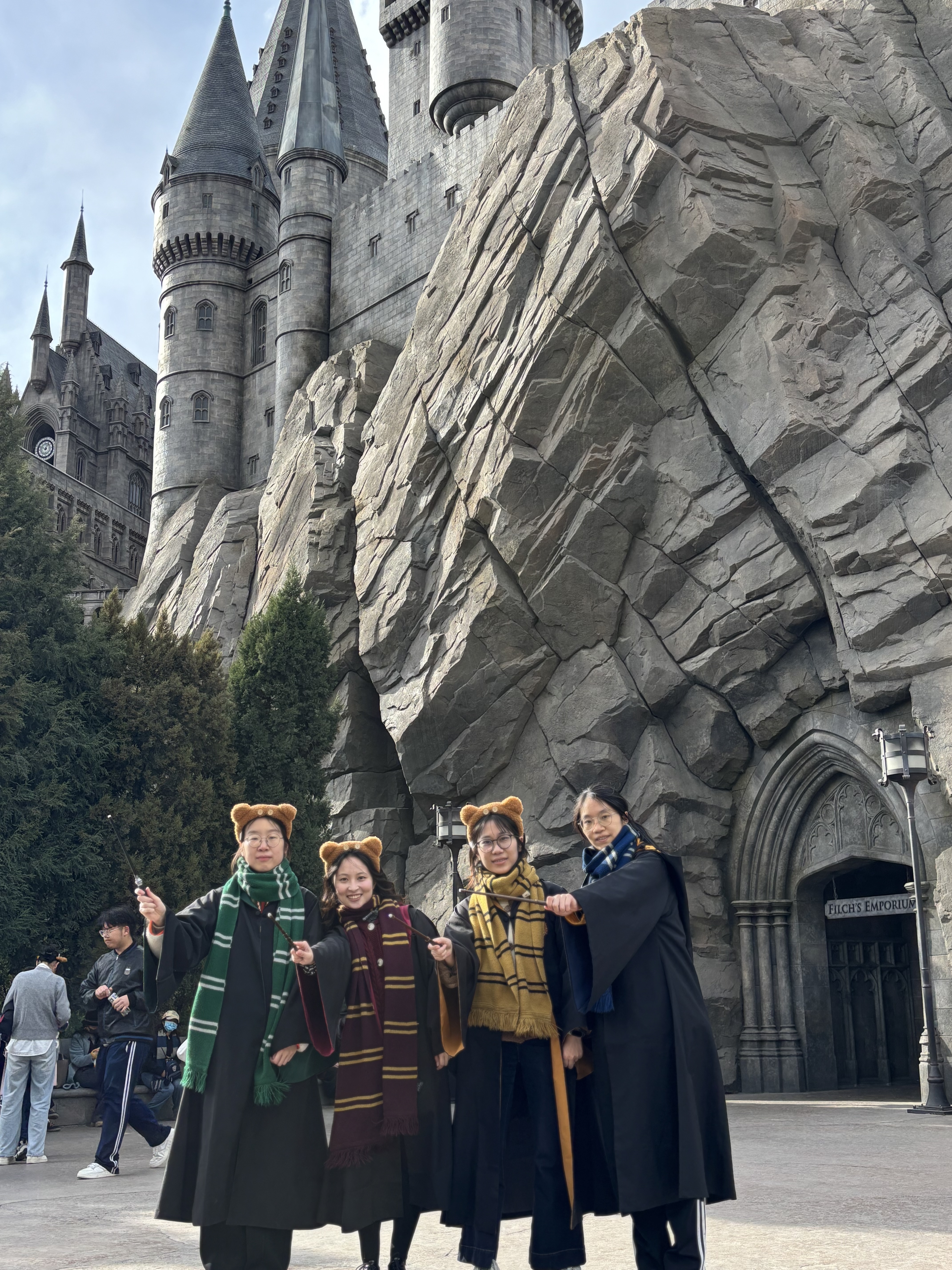 A group in wizard robes in front of the castle at Universal Studios