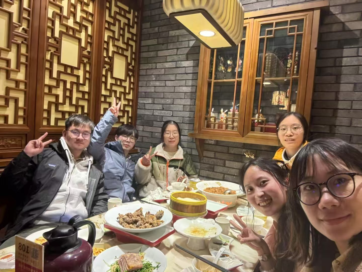 A cheerful group snapshot around the dinner table