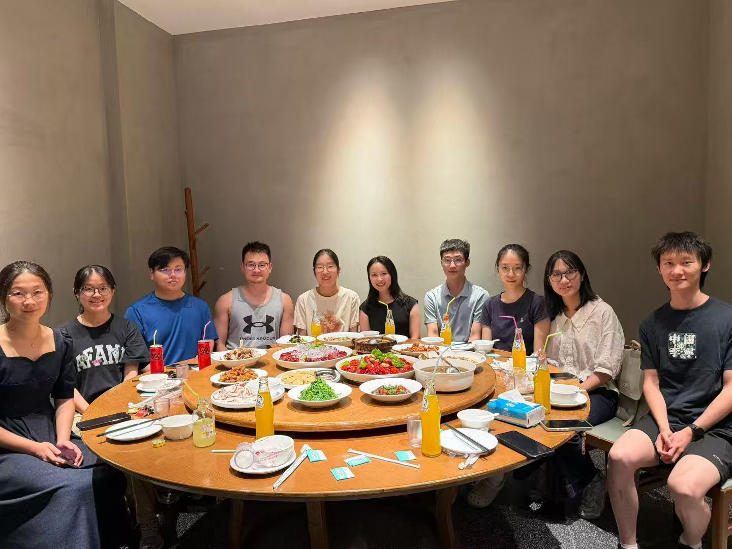 A group photo around a round dining table